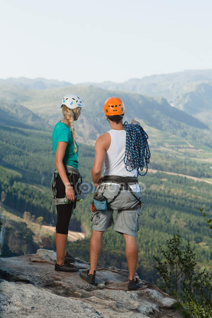 Climbers overlooking rural valley — Stock Photo