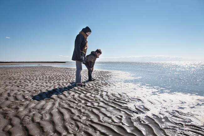 Grandmother and grandson on beach — Stock Photo