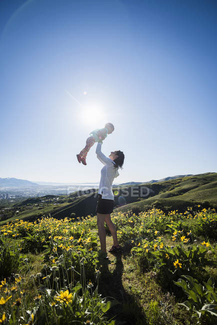 Mother and daughter in field, hiking the Bonneville Shoreline Trail in the Wasatch Foothills above Salt Lake City, Utah — Stock Photo