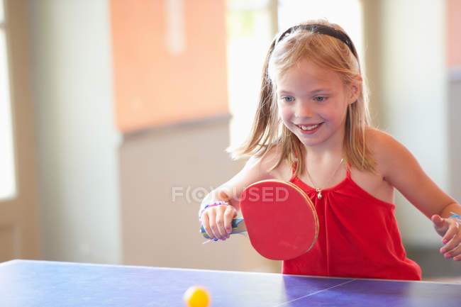 Девочка играет в настольный теннис, избирательный фокус — стоковое фото
