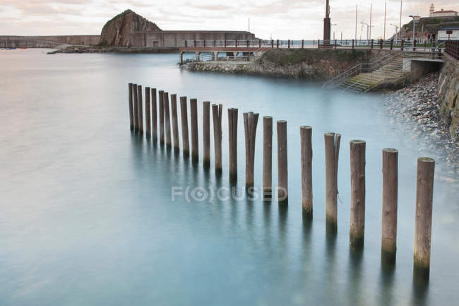 View of wooden posts in water — Stock Photo
