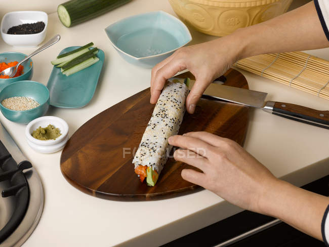 Woman rolling sushi — Stock Photo
