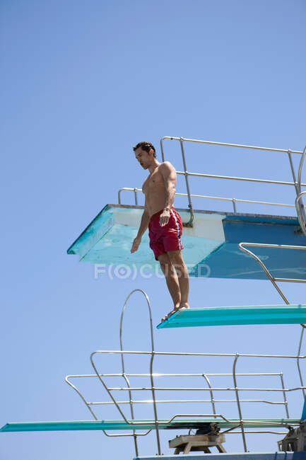 Man standing on a spring board — Stock Photo