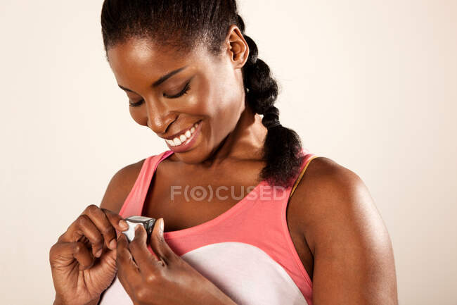 Young woman holding stopwatch — Stock Photo