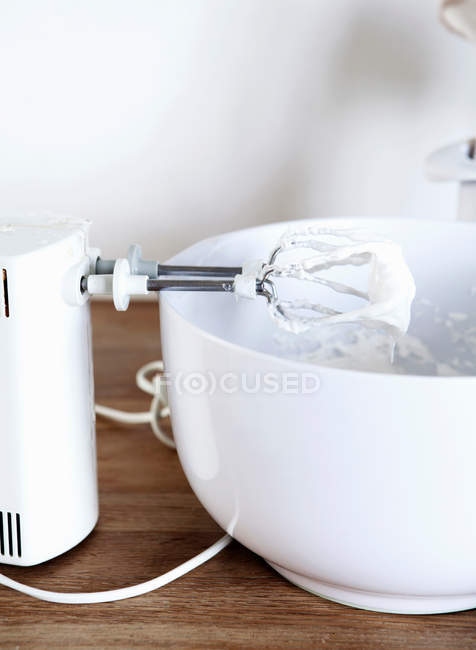 Electric mixer with whipped cream — Stock Photo