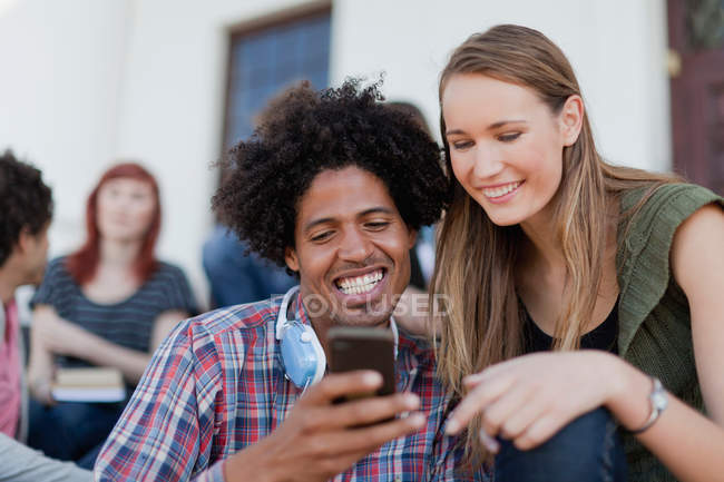 Students using cell phone on campus — Stock Photo