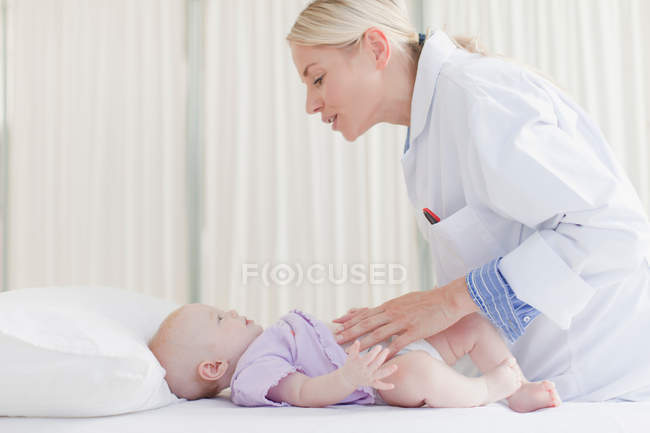 Doctor examining baby in office — Stock Photo