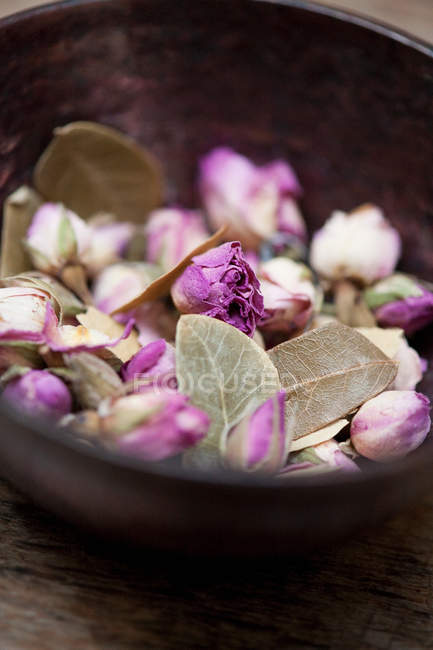 Close up of wooden bowl with violet potpourri — Stock Photo