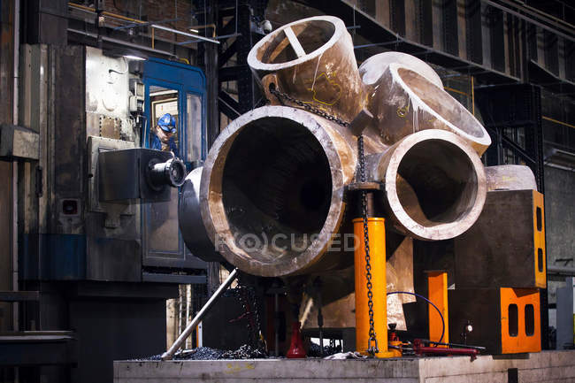Worker using machinery in steel forge — Stock Photo