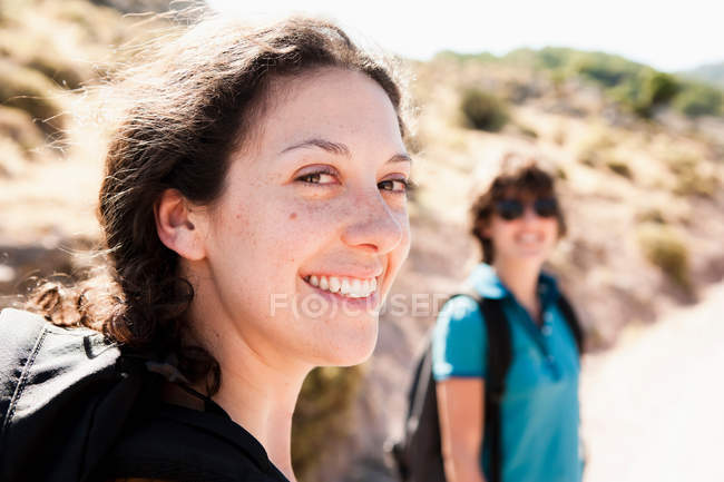 Women smiling outdoors, selective focus — Stock Photo