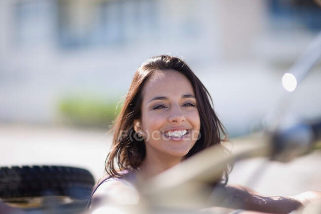 Mujer joven en un convertible - foto de stock