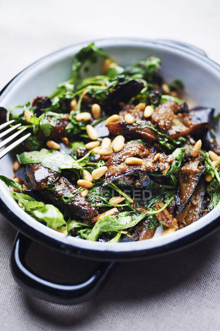 Aubergine with pine nuts and spinach — Stock Photo