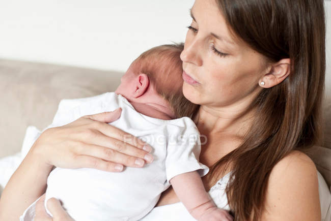 Mother holding infant son — Stock Photo
