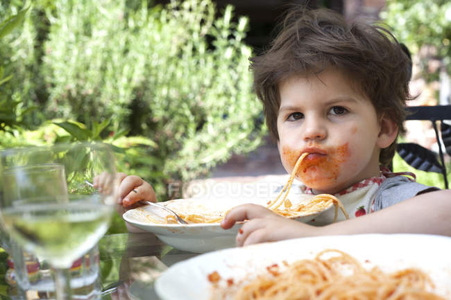 Portrait of male toddler eating spaghetti — Stock Photo