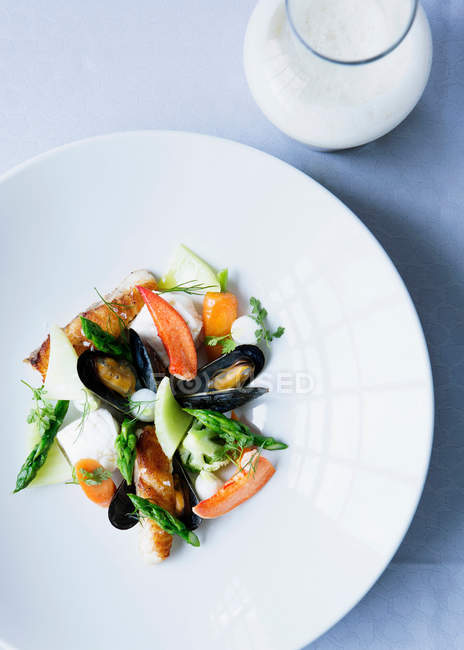 Mussels with salad on plate — Stock Photo