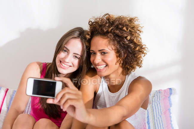 Жінки фотографуються з мобільним телефоном — стокове фото