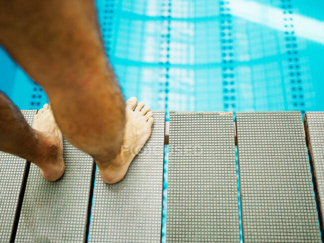 Man standing on diving board close-up — Stock Photo