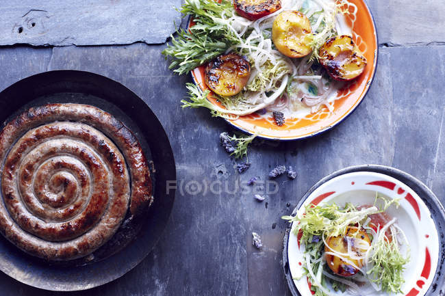 Toulouse sausage in frying pan — Stock Photo