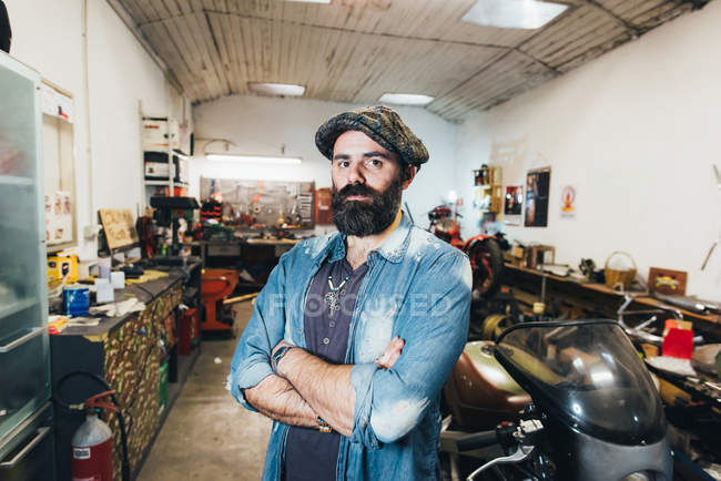 Portrait of mature man, in garage — Stock Photo