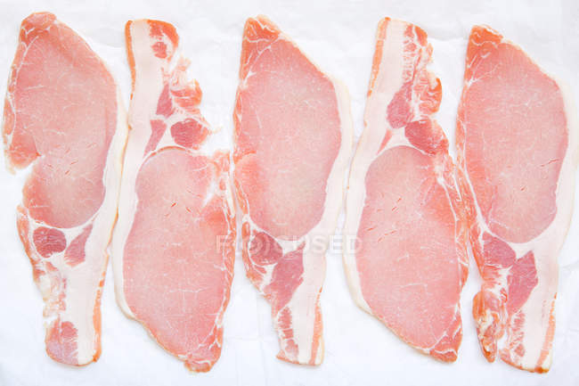 Bacon slices on baking tray, top view — Stock Photo