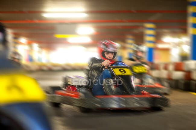 Young woman racing on go cart track — Stock Photo