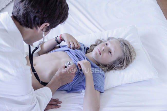 Doctor using stethoscope on boy — Stock Photo