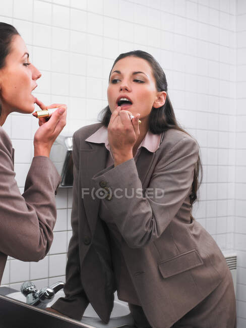 Woman reflected in office mirror — Stock Photo
