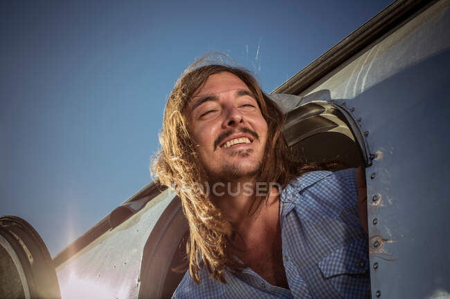 Close-up of a man leaning out of caravan door — Stock Photo
