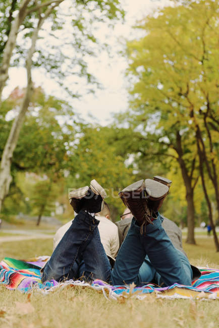 Gay coppia sdraiato su stomaco in parco — Foto stock