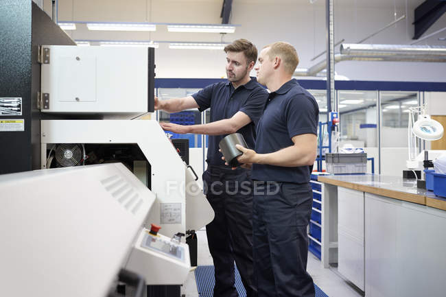 Workers checking control panel in engineering factory — Stock Photo