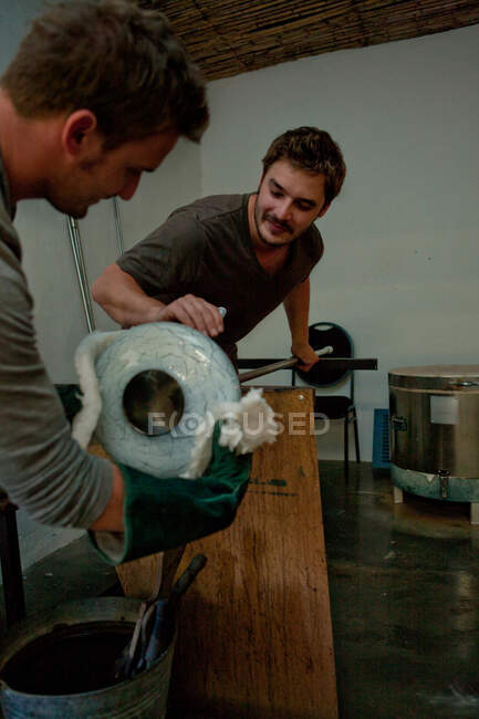 Two men working in glass factory — Stock Photo