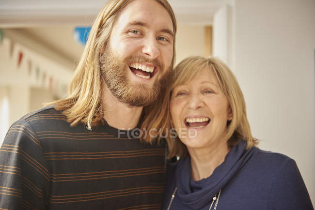 Portrait of mature blond woman and adult son at home — Stock Photo