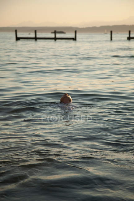 Mann schwimmt auf dem Rücken im Wasser — Stockfoto