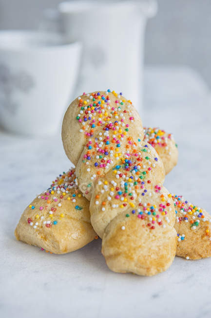 Italian cookies with colourful sprinkles on table — Stock Photo