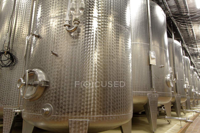 Stainless steel vats on wine cellar — Stock Photo