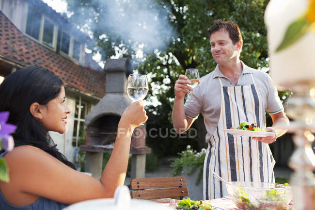 Couple raising toast with glass of water — Stock Photo
