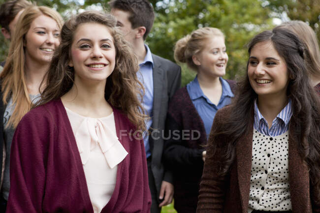 Students walking together in park — Stock Photo
