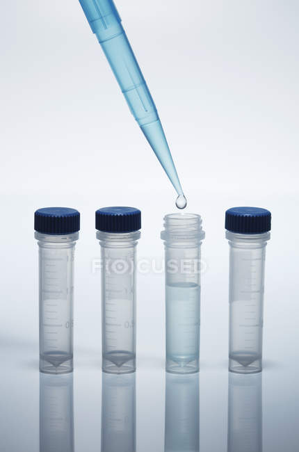 Micro pipette and four test tubes — Stock Photo