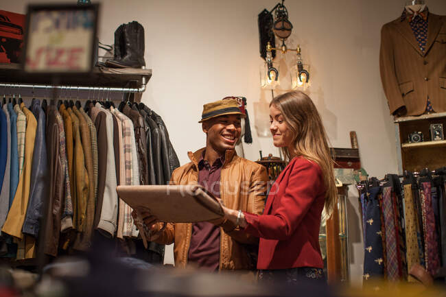 Young couple in vintage clothes shop — Stock Photo