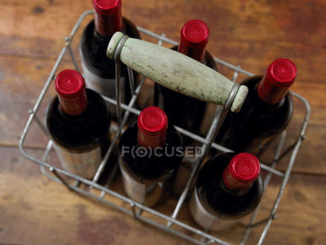 Wine bottles in basket — Stock Photo