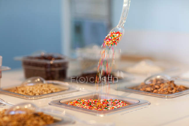 Sprinkles pouring from spoon — Stock Photo