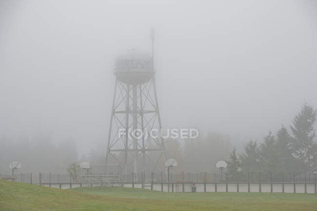 Water tower on foggy day — Stock Photo
