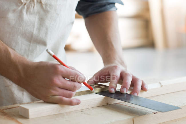 Carpenter using mitre in workshop — Stock Photo
