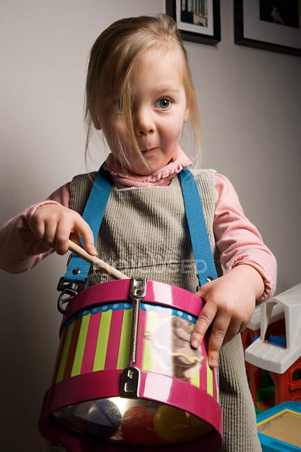 Chica tocando un tambor - foto de stock