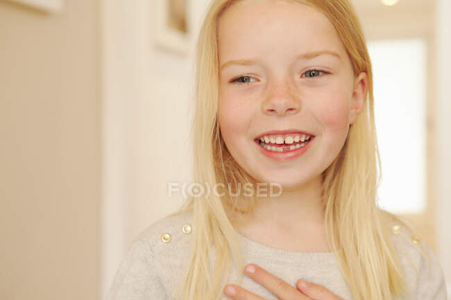 Молодая девушка улыбается, смотрит в сторону — стоковое фото