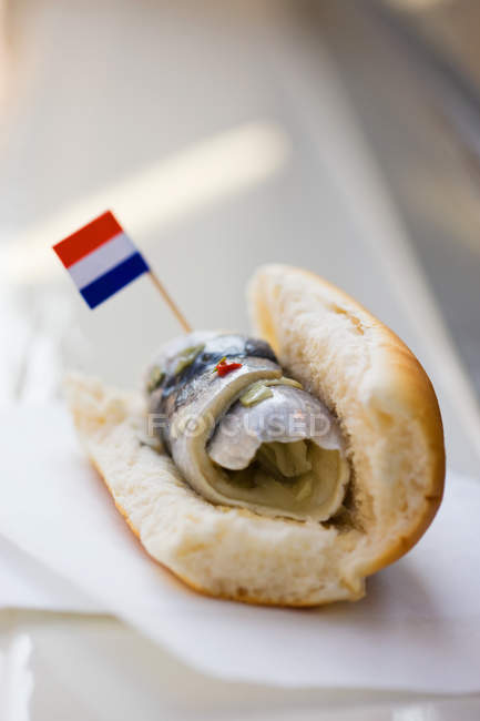 Rollmop in bread roll with Dutch flag — Stock Photo