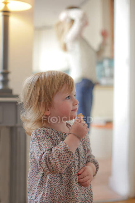 Portrait of toddler eating snack — Stock Photo