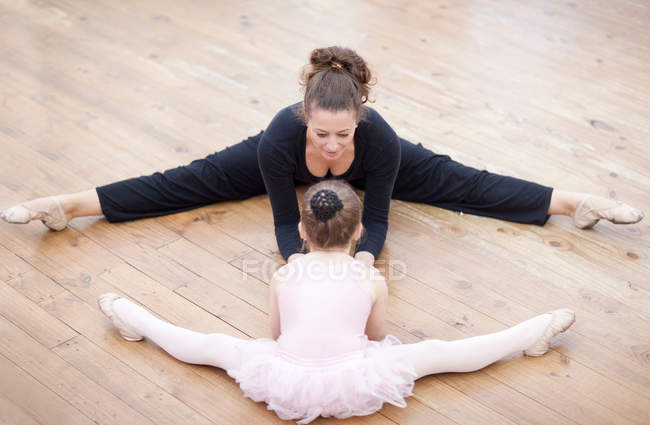 Professor e bailarina alongamento no chão — Fotografia de Stock