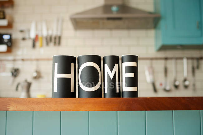 Word 'Home' on kitchen counter — Stock Photo