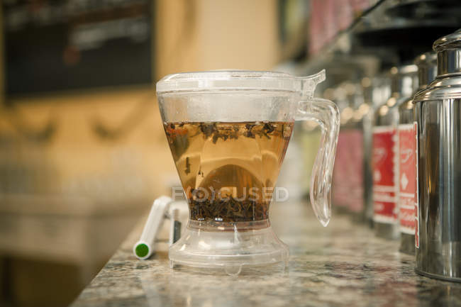 Cup of herbal tea on table in cafe — Stock Photo